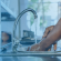 A person washing their hands at a kitchen sink - Prevent the spread of germs